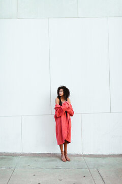 Young woman in a pink coat