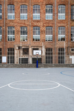 Basketball court with old factory facade behind