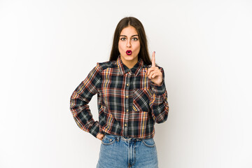 Young caucasian woman isolated on white background pointing upside with opened mouth.