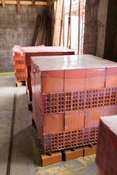 Packed bricks piles on pallets on building site