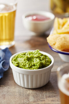 Traditional mushy peas on wooden table