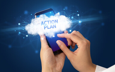 Female hand touching smartphone with ACTION PLAN inscription, cloud business concept
