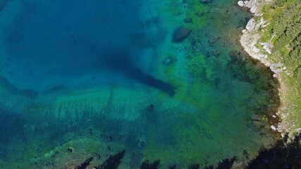 Carezza lake, beautiful shot in the dolomites, Bolzano province, South tyrol, Italy aerial view