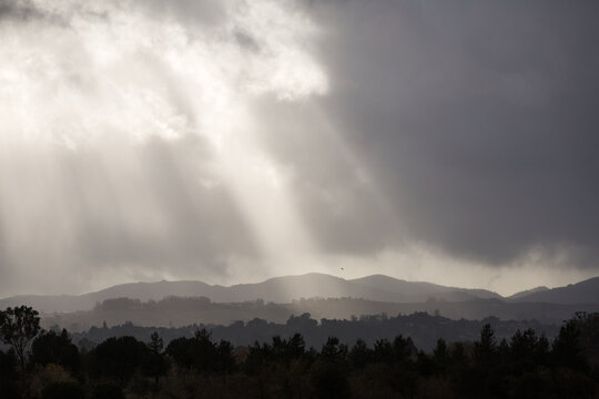 Rays of sunlight in cloudy weather over landscape