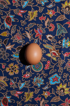 An egg on a colorful pattern.