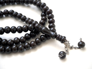 99 Islamic prayer beads on a white background,