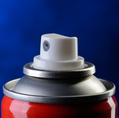 Detail of spray can on blue background