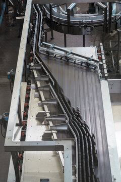 Beer bottles at packaging facility on mechanical belt