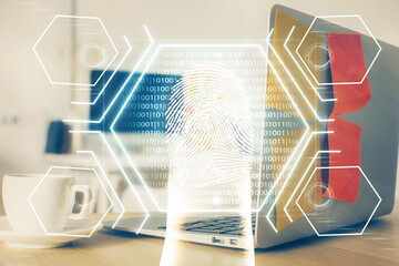 Computer on desktop in office with finger print drawing. Double exposure. Concept of business data security.
