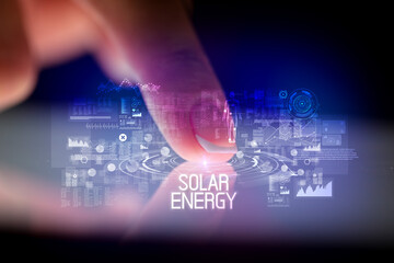 Finger touching tablet with web technology icons and SOLAR ENERGY inscription