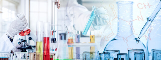 hand of scientist holding flask and pouring sample to test tube in chemical laboratory background,...