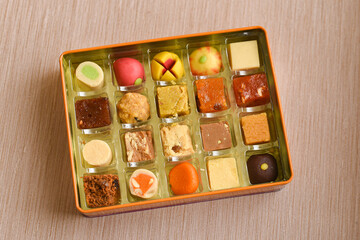 Indian sweets, Diwali sweets mithai milk Peda and Halwa or Halva, flavored variety of assorted dessert in box to gift on Deepavali, Pongal, Durga Pooja, Holi, Diwali festival in India.