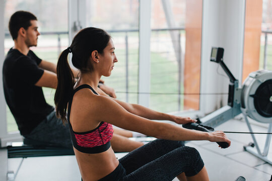 Woman and man working out in the gym