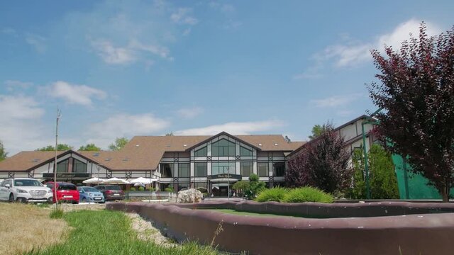 Building of vacation center country nature hotel with parking slow motion push out backward camera movement