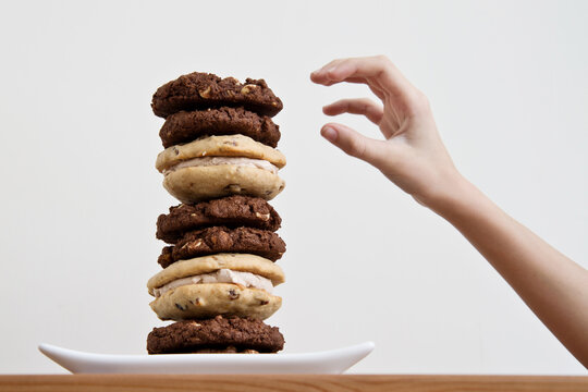 Child reaching for cookie dessert