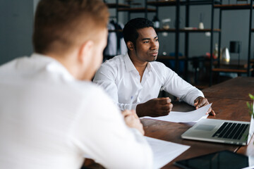 Fototapeta premium Portrait of handsome African American business man listening business idea, increasing sales, analyzing statistics, work results report, negotiating on new business project.