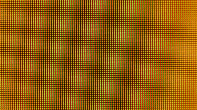 Old LCD pixels background. Macro shot of computer screen, pixel texture. Abstract rainbow background. Close the LED screen with Color Shades technology. Closeup monitor. Illumination wallpaper sample.
