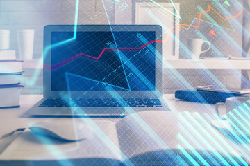 Financial market graph hologram and personal computer on background. Double exposure. Concept of forex.