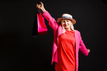 Elegant woman holding black shopping bags, black friday concept