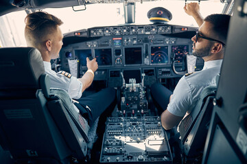 Two handsome man sitting on the chair in cockpit © Svitlana