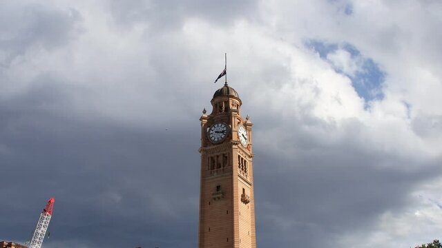 Time-lapse of fast dark moving Clouds over a clock tower in Sydney CBD Australia