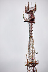 Telecommunications Cell Phone tower with mobile antennas on blue sky background