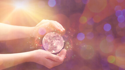 protective hands over the moon