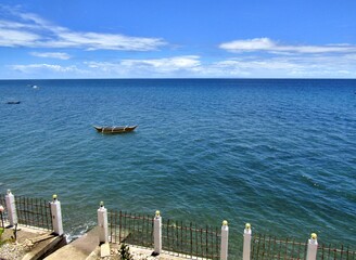 Blue sea with a fishing boat against the blue sky in the Philippines