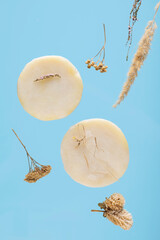 Natural handmade soap based on herbal decoction on a blue background.