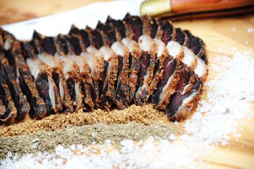 Traditional marbled South African Beef Biltong with spices and a carving knive