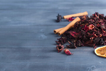 hibiscus flowers lie on a wooden table. brew tea