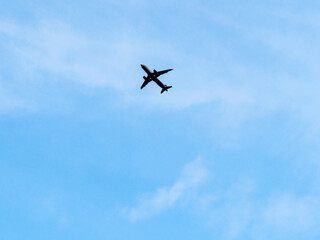 bottom view of airplane in blue evening sky