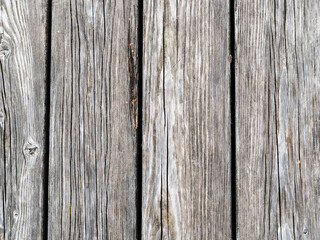 shabby gray wooden planks of outdoor paving of pier close up