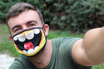 Man taking a selfie with fun PPE