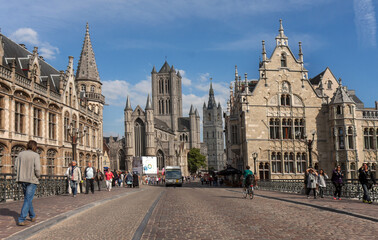 Fototapeta premium Ghent, Belgium: view on the St Michael’s Church and sunlit historic houses from the St Michaels bridge in the medieval city centre of Ghent. 
