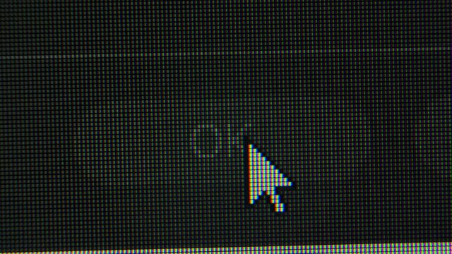 The cursor arrow moves across the screen and clicks on the OK button. Screen monitor pixels close up. Red, blue and green subpixels create the image on the screen.
