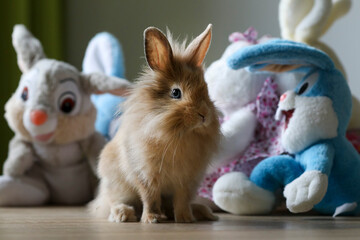 Cute lively bunny among plush bunnies