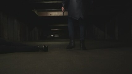 Unrecognizable killer with gun in hand hiding from the crime scene. Terrorist or robber shot man. Slow motion Rear back view - Powered by Adobe