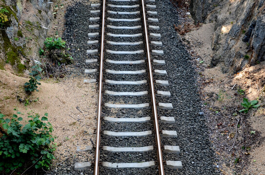 railway track with concrete sleepers tracks are in an inaccessible gorge where soil and rocks often fall on the tracks, landslides can stop or derail the train