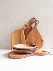 Set of wooden kitchenware - cutting board and bowls. copy space
