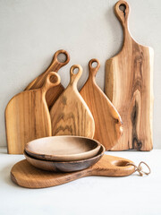 Set of wooden kitchenware - cutting board and bowls. copy space