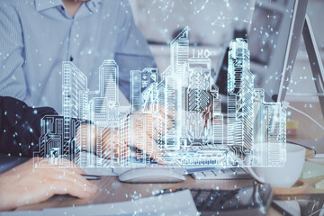 High tech city drawing with businessman working on computer on background. Smartcity concept....