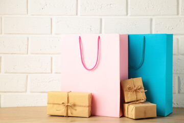 Pink and blue shopping bags with gift on light background. Black friday