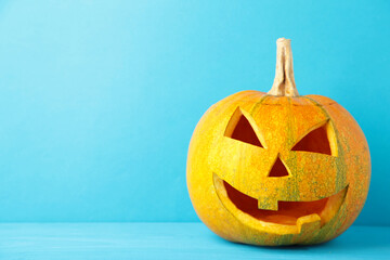 Halloween pumpkin head jack lantern on blue background
