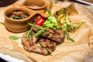 Grilled meat with green, vegetables and sauce