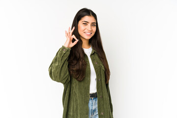Young indian woman isolated on purple background cheerful and confident showing ok gesture.