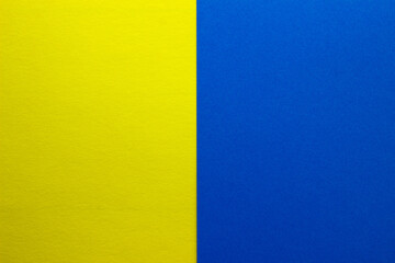 Background of two vertical rectangles yellow and blue. Sheets of blank yellow and blue paper with...