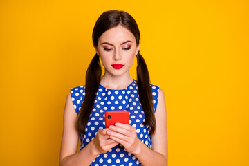 Close-up portrait of her she nice-looking attractive pretty lovely glamorous focused serious girl using device gadget browsing web service isolated bright vivid shine vibrant yellow color background