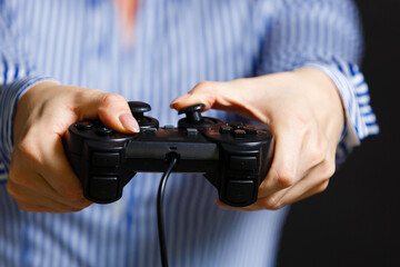 Female hands with a gamepad. Isolated on black background