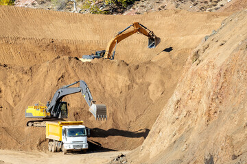 The excavators are working in the construction site.